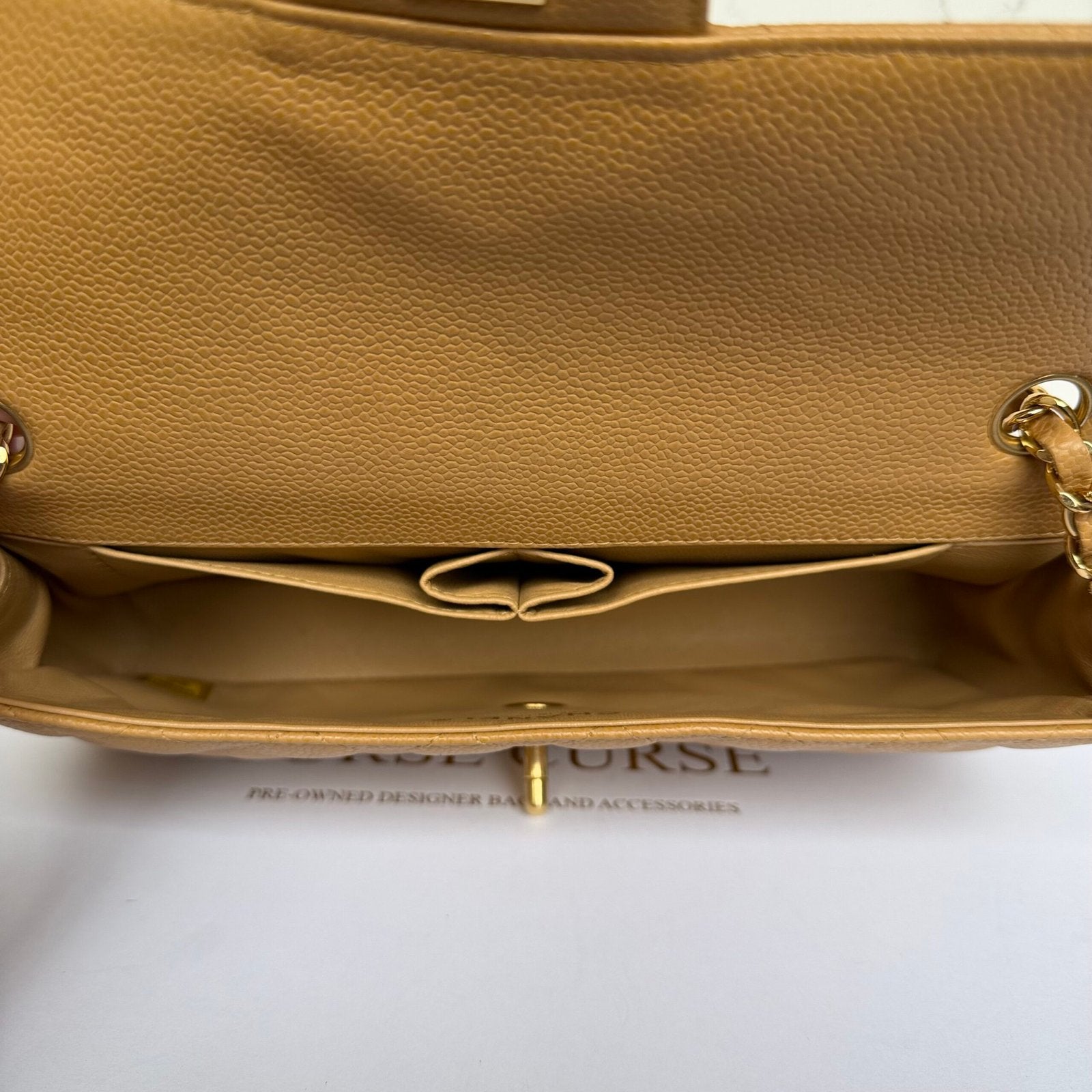 Inside Chanel East West flap beige caviar
