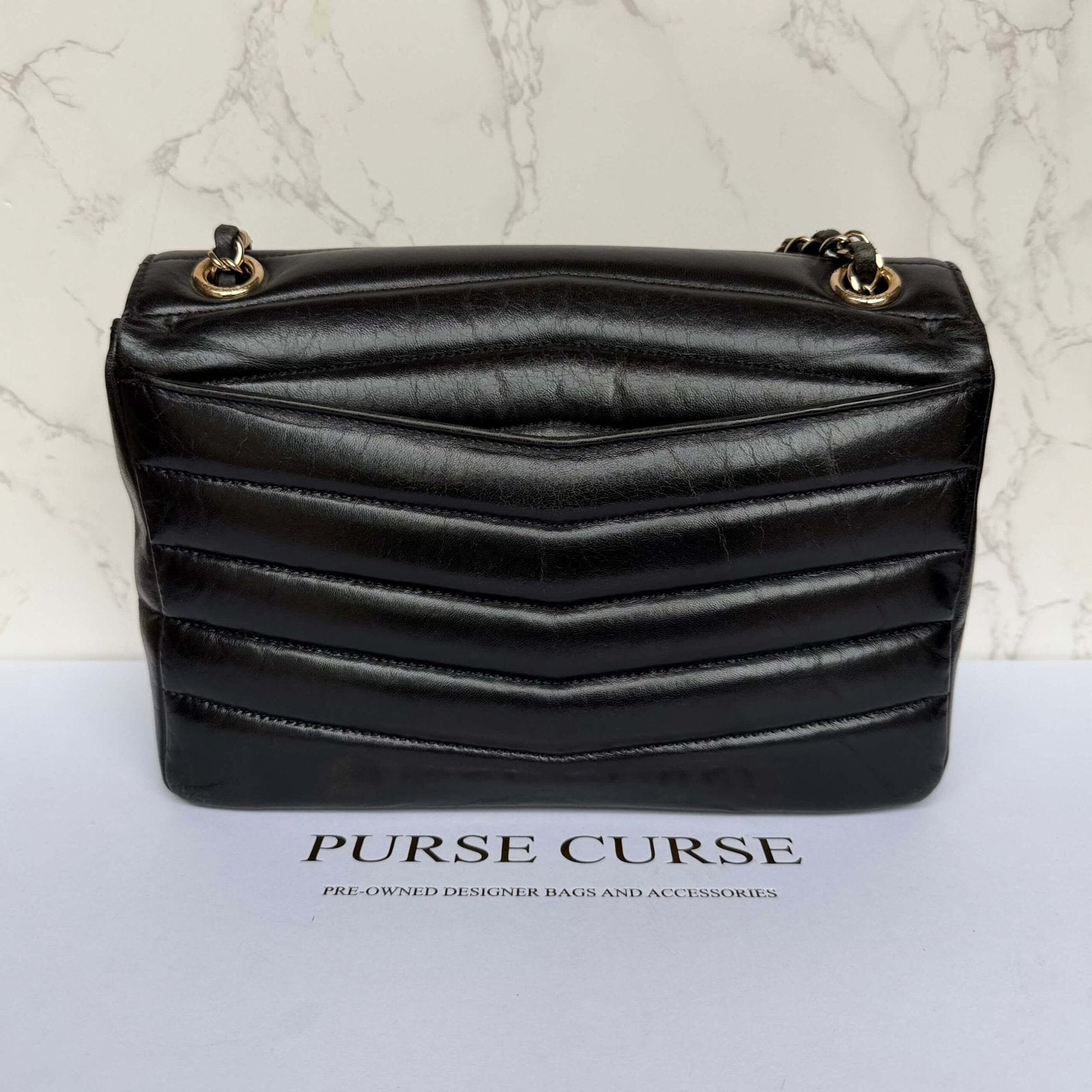 Back view black Chanel shiny calfskin flap bag