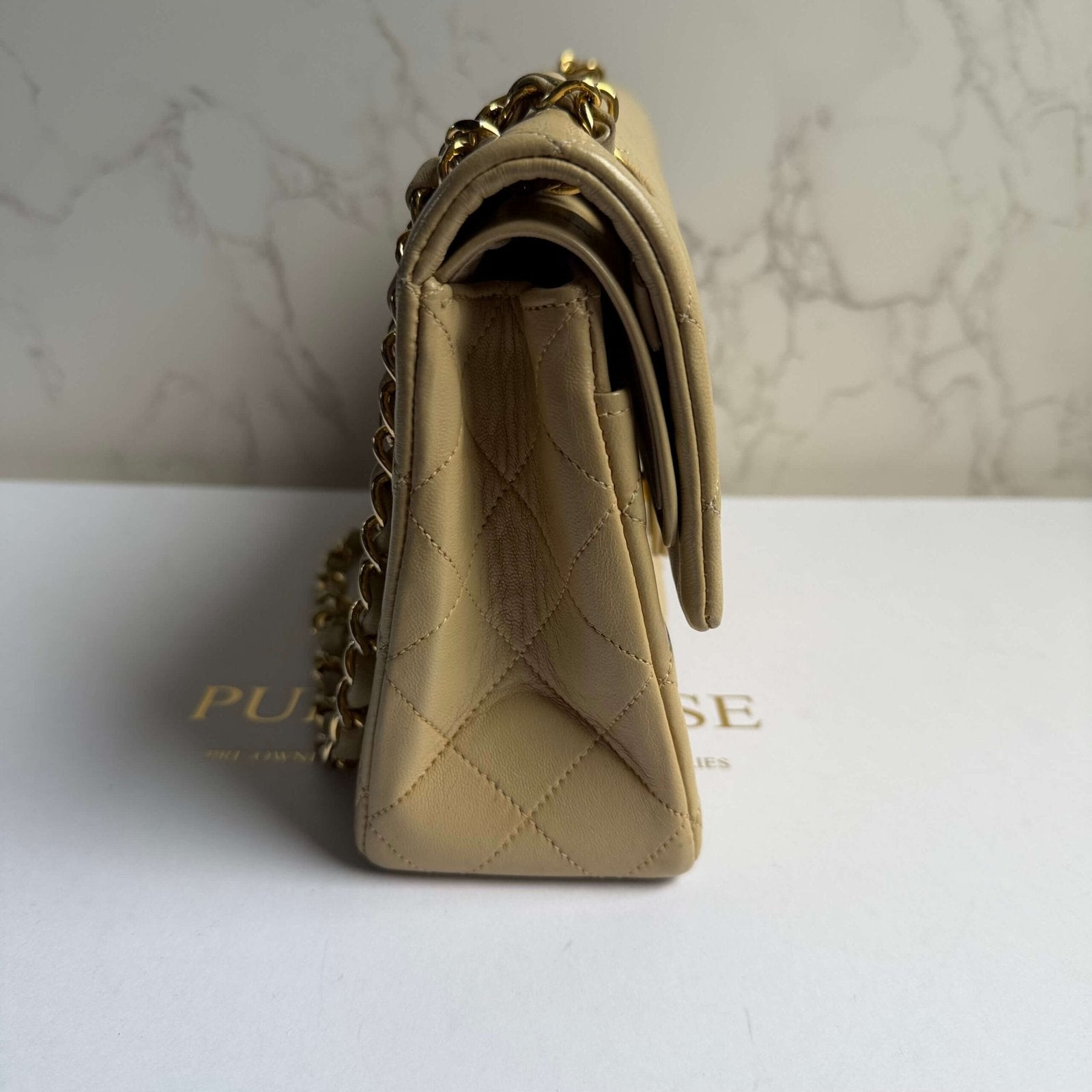 Side view Chanel small classic flap beige lambskin