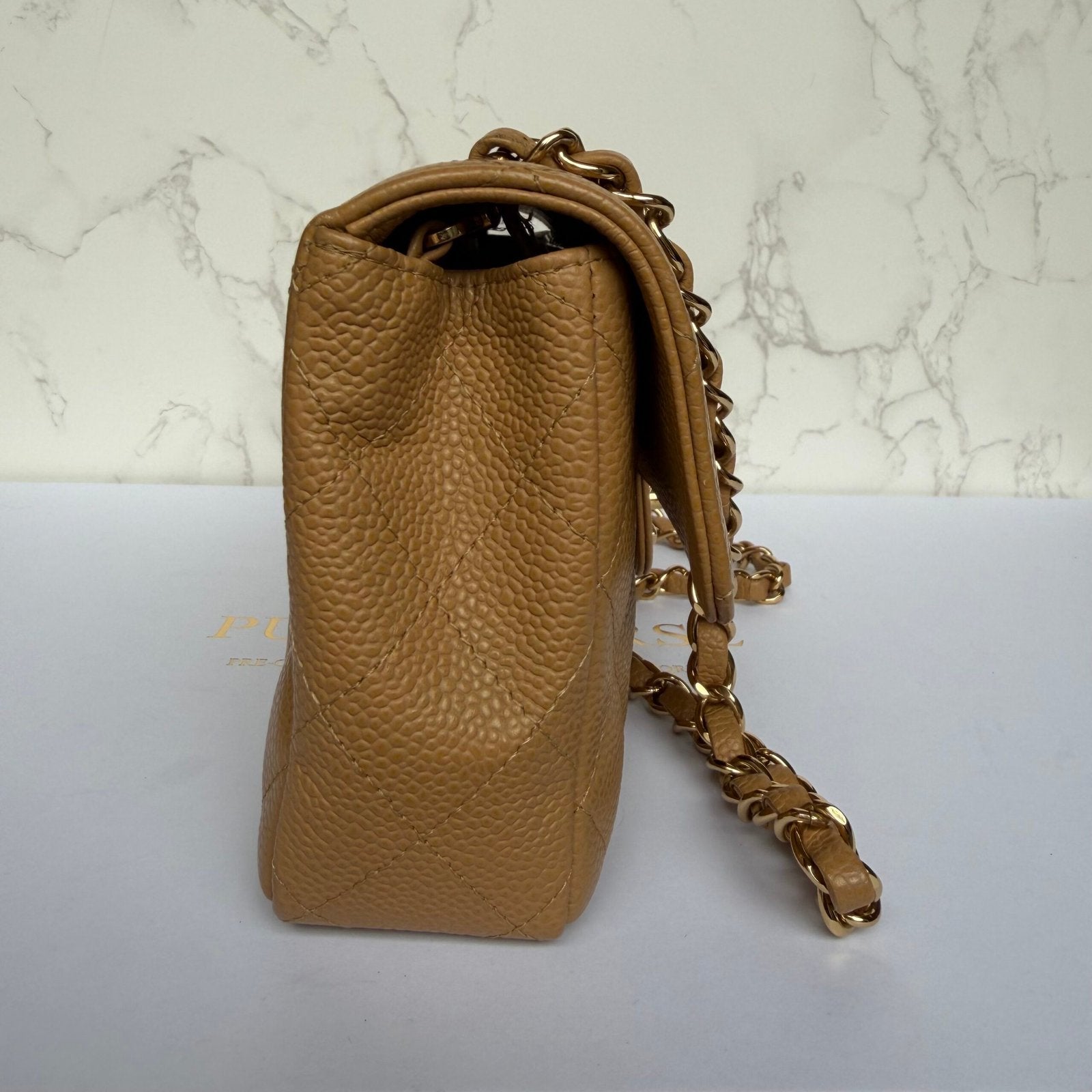 side Chanel East West flap beige caviar