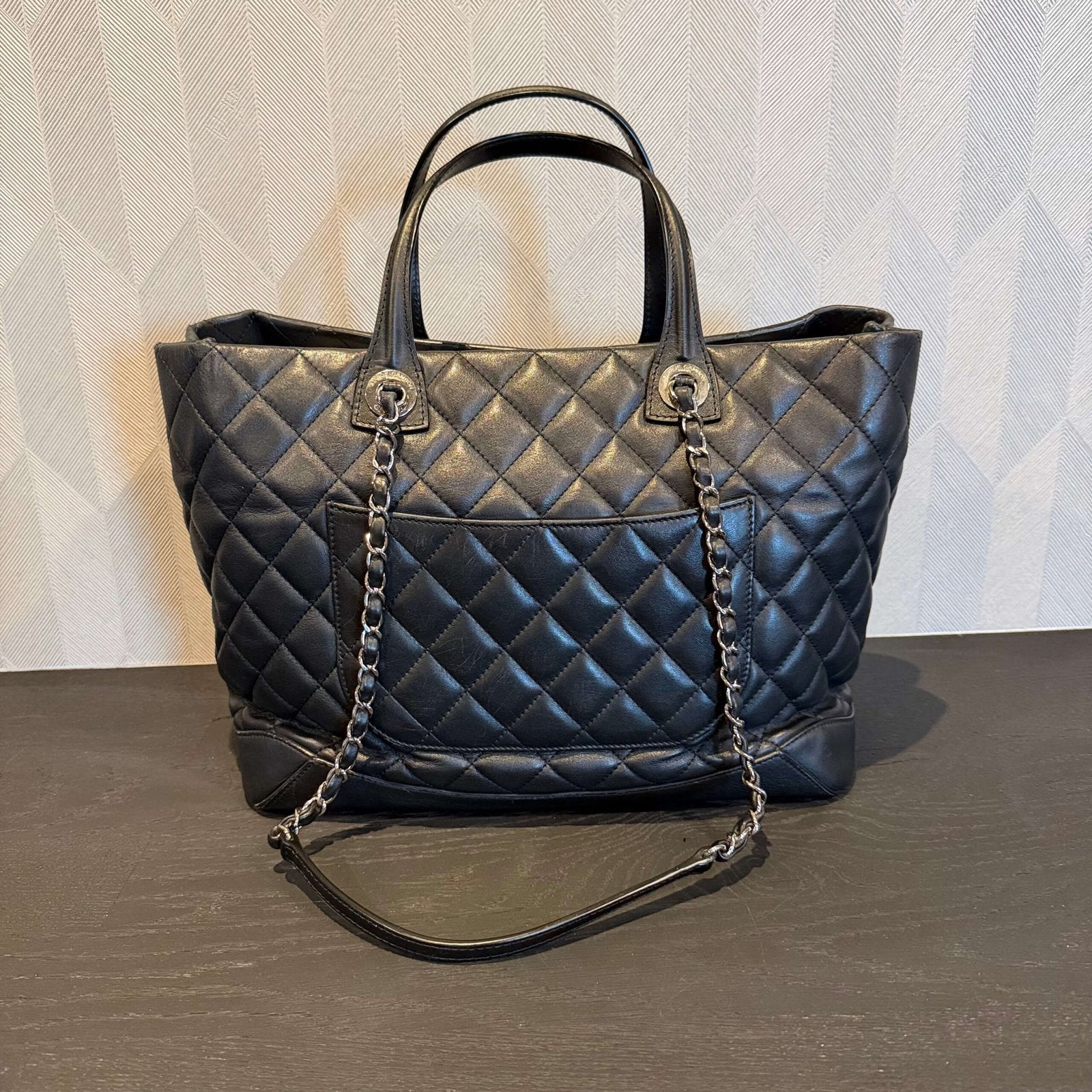 Backside of authentic Chanel large black calfskin tote bag