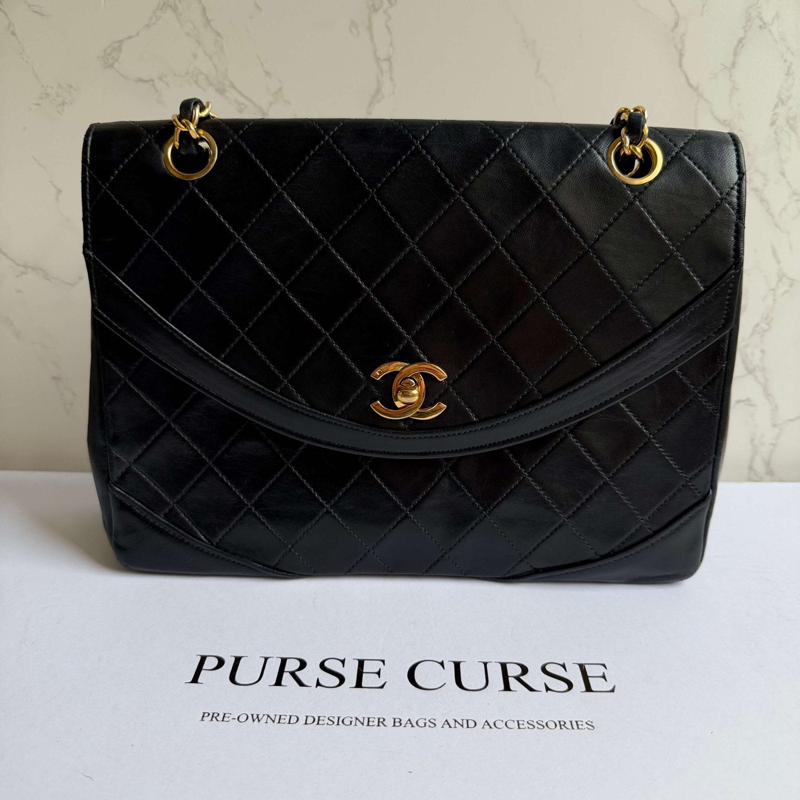Chanel double chain flap bag black with gold hardware detail