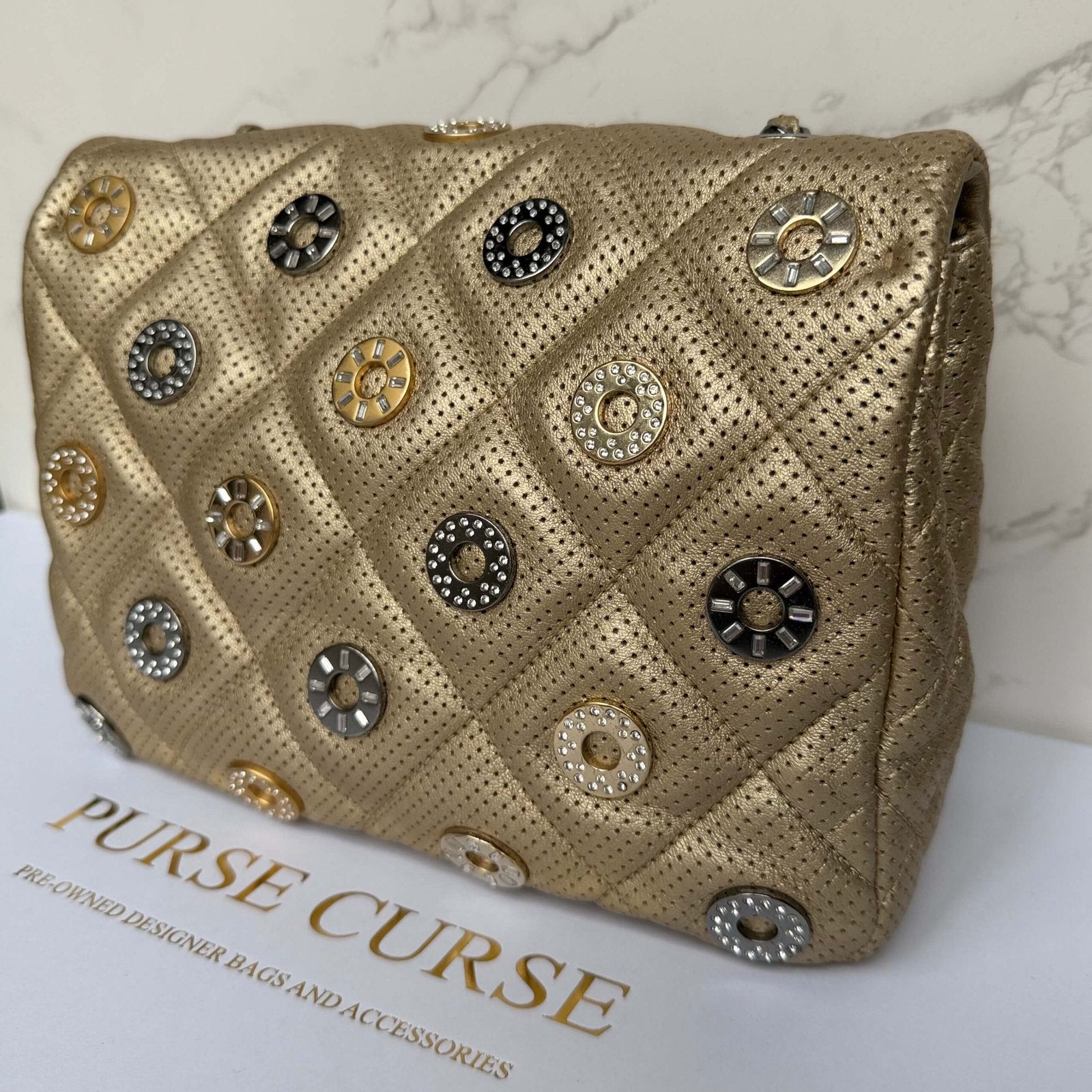 Chanel perforated gold leather flap