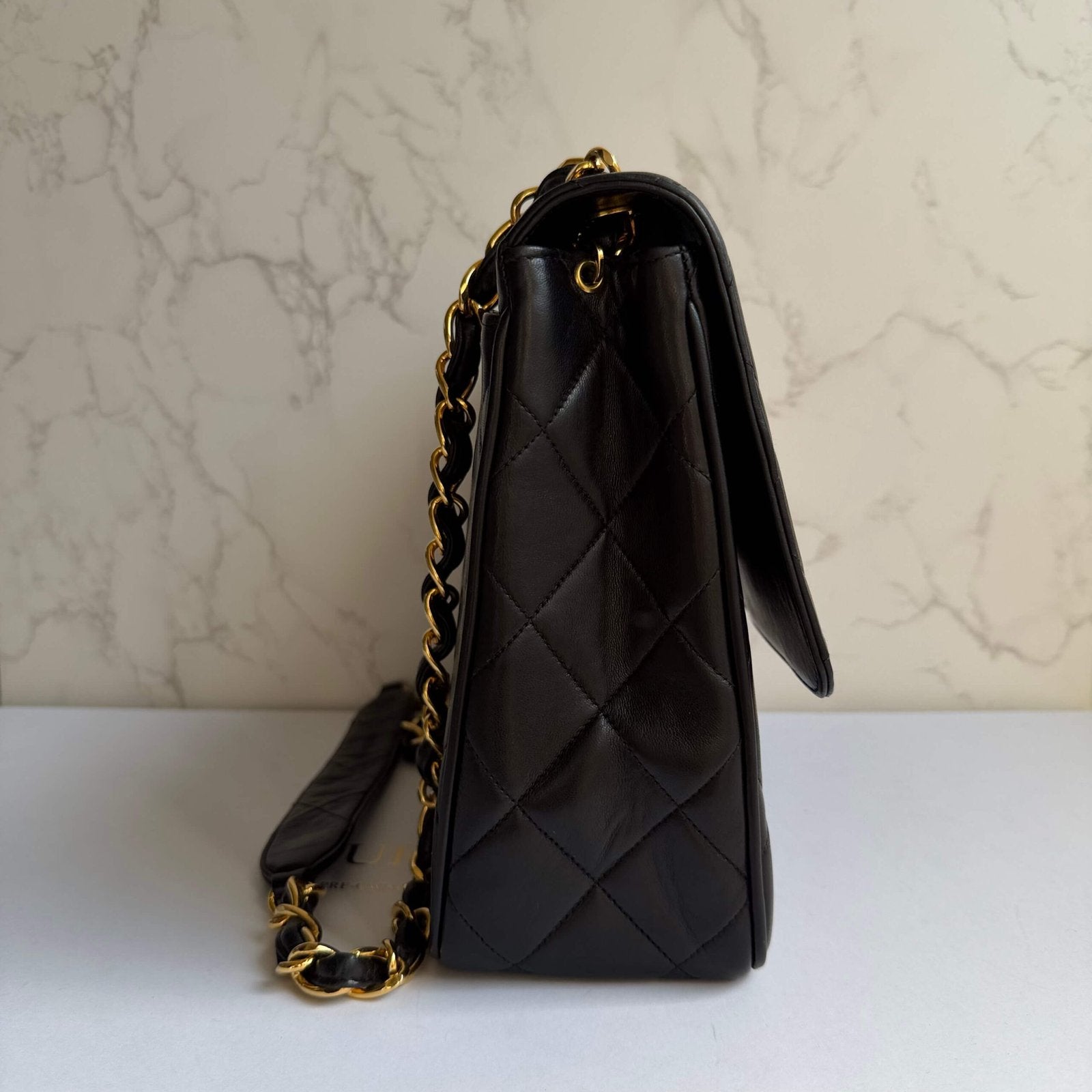 Chanel black lambskin leather Chanel bag side view