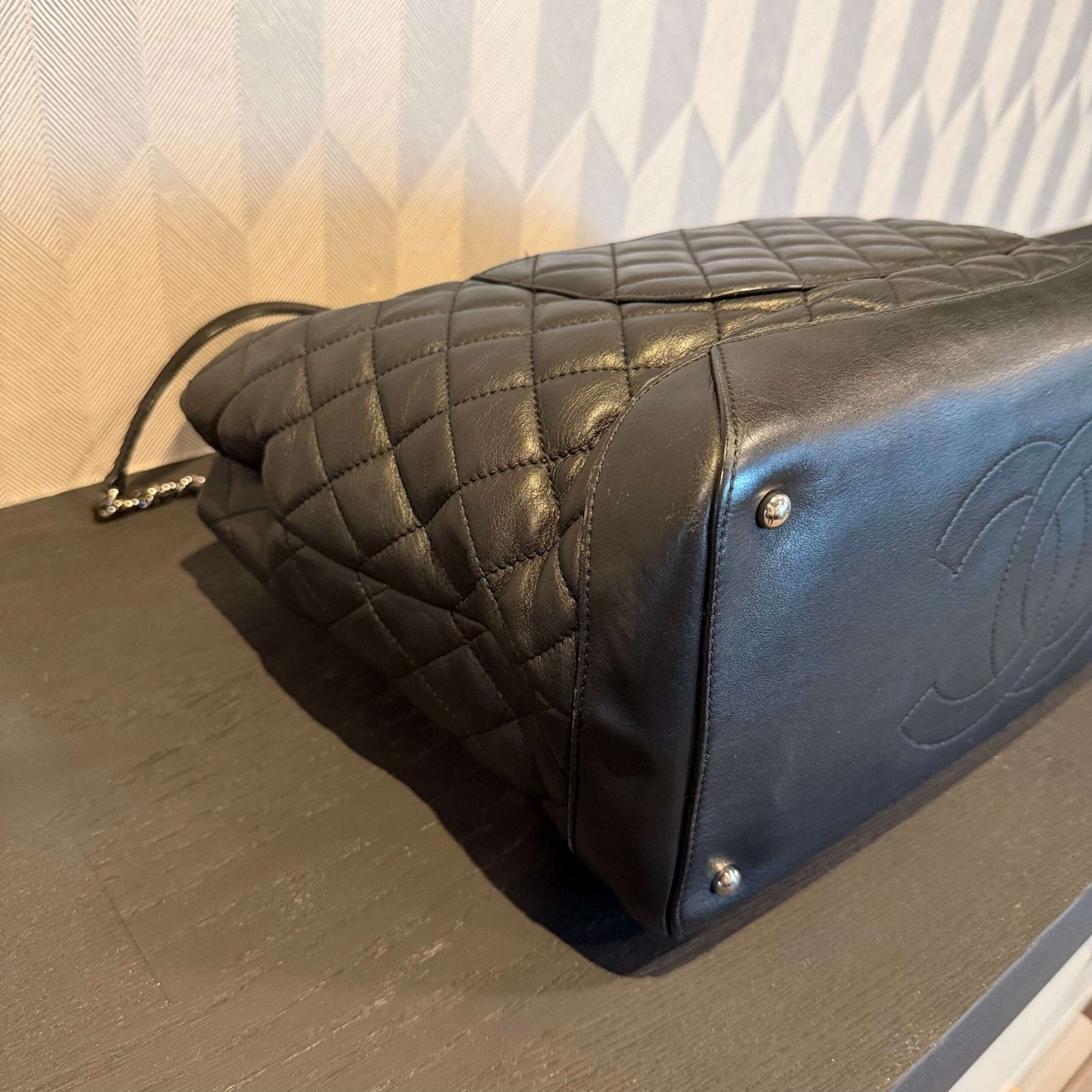 Corners of original Chanel calfskin shopping tote with silver-tone hardware