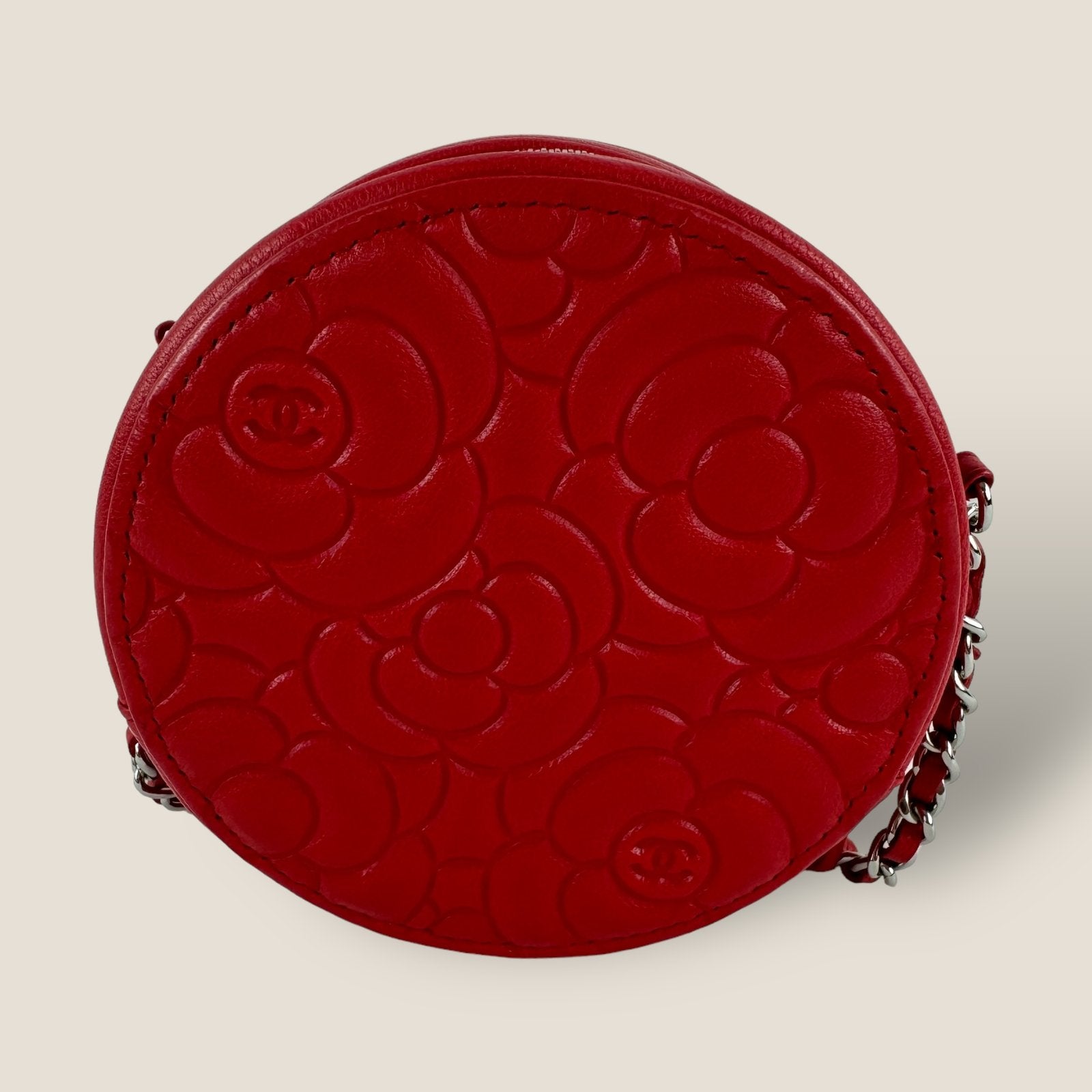 Back of Chanel mini shoulder bag round model with camellia print in red leather