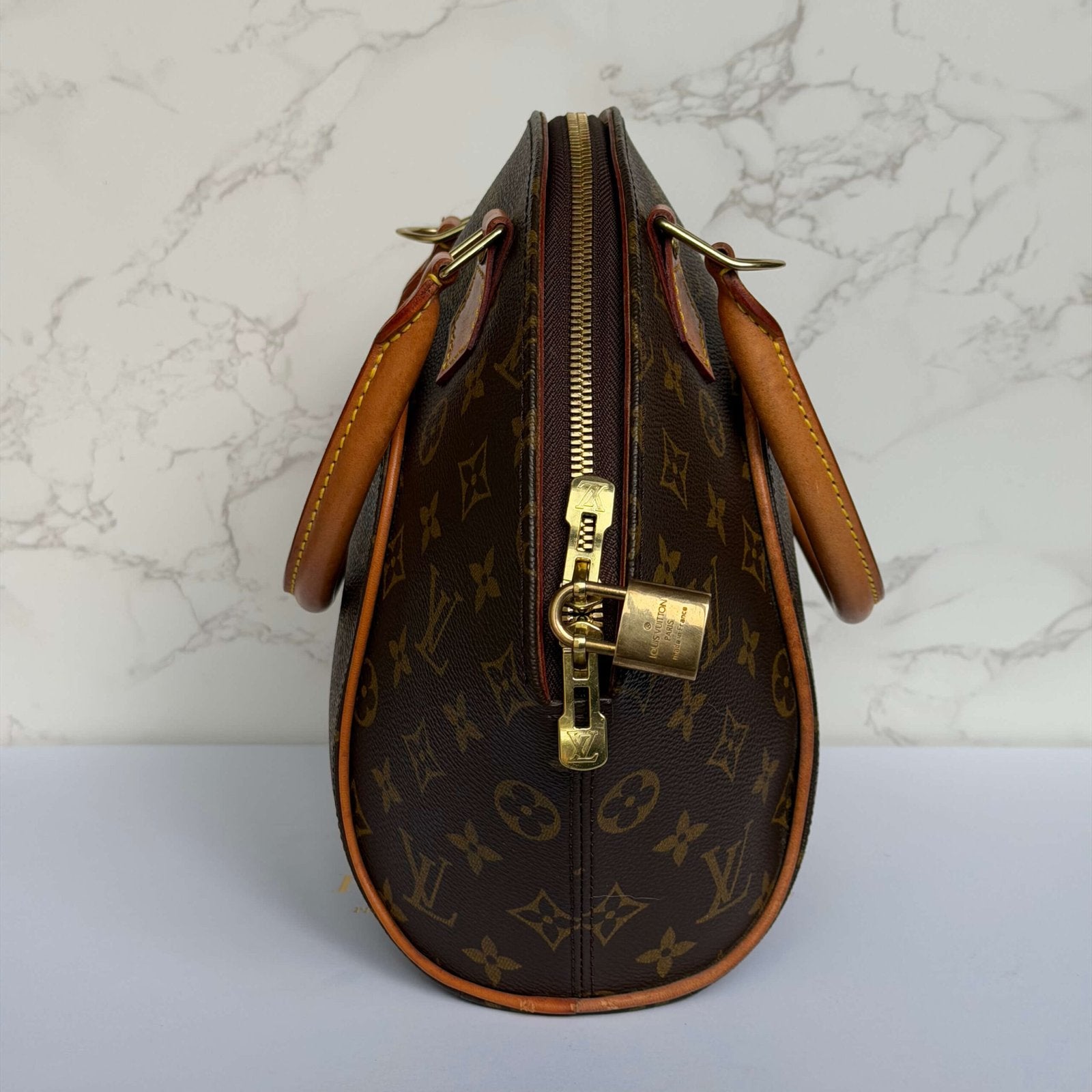 Side view of small Louis Vuitton Ellipse handbag