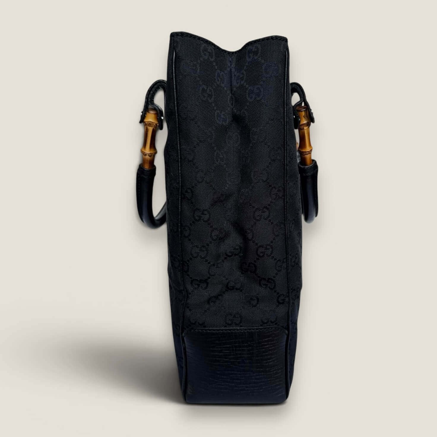 Side of vintage Gucci black canvas handbag